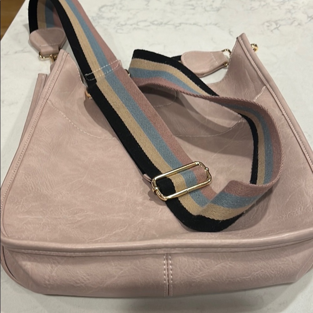 Pink pocketbook with strap.   Limited use